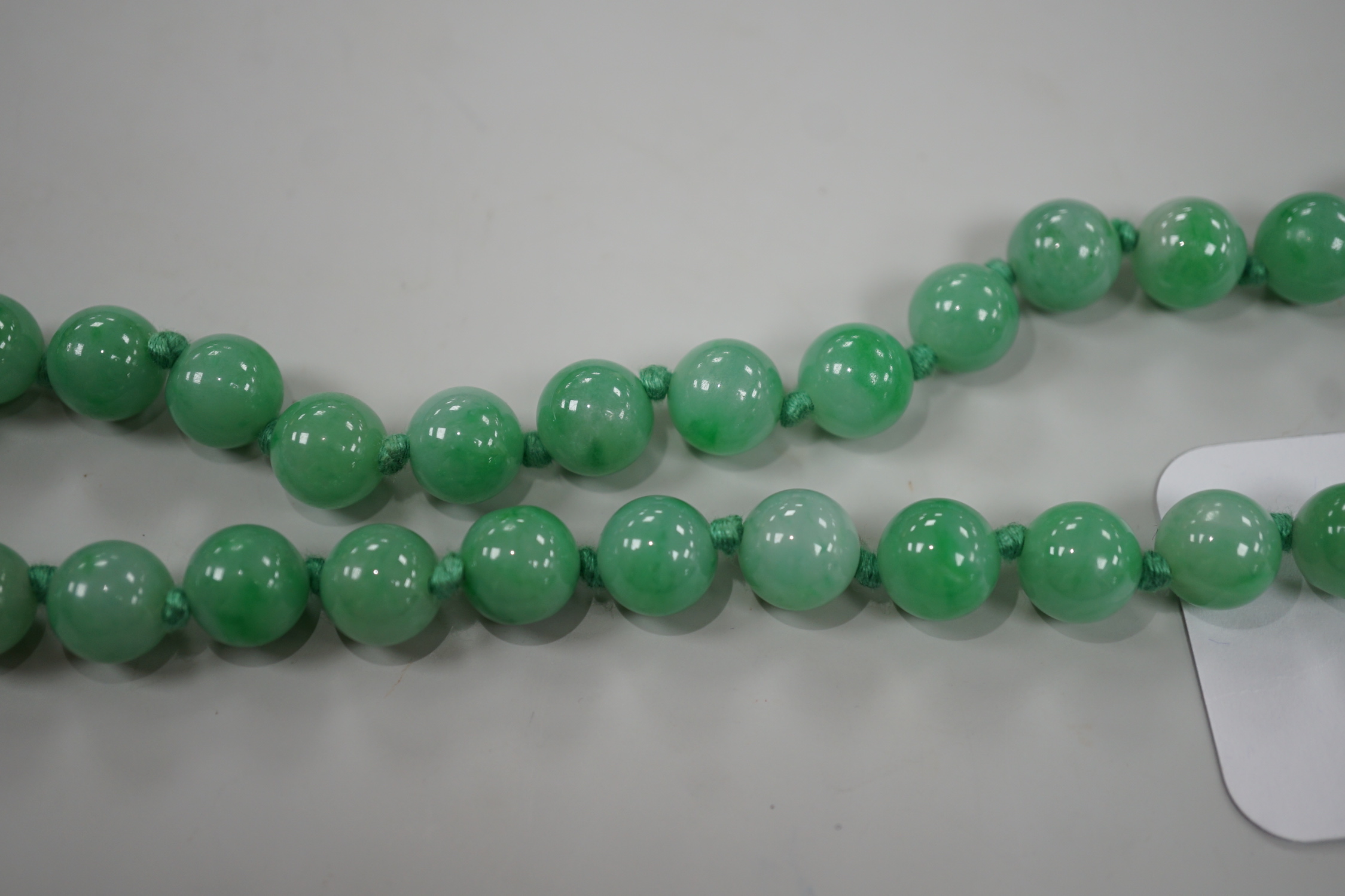 A single strand jade bead necklace, 58cm, gross weight 91 grams.